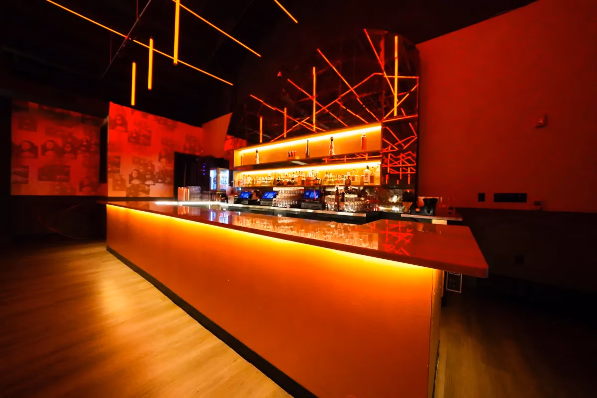 Mr. Ivy bar with red lighting and long counter — commercial nightlife venue by Treacy Brothers
