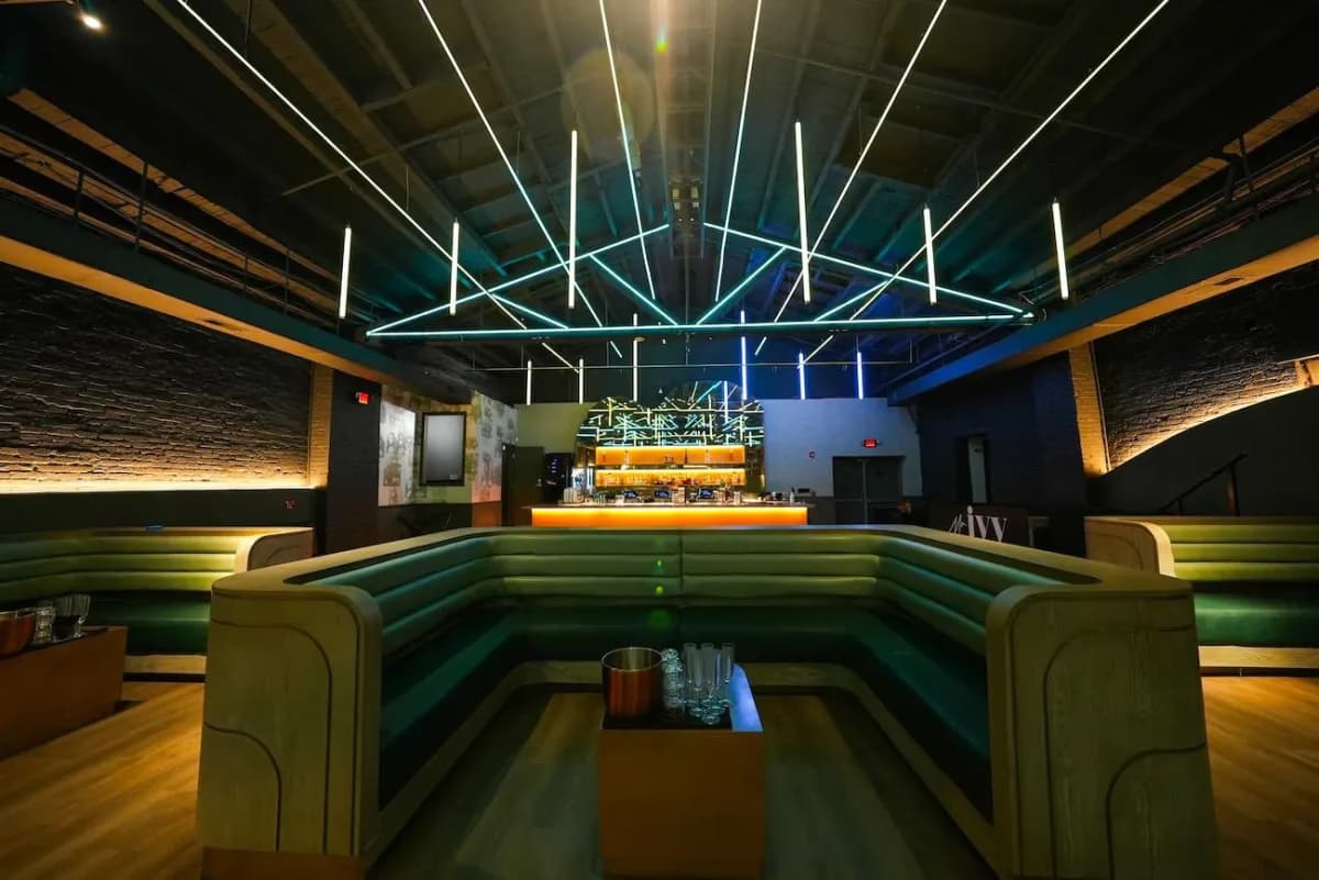 Mr. Ivy venue — teal LED lounge with booth seating, commercial project by Treacy Brothers